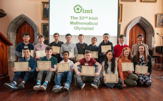 Two rows of students with Roll of Honour Scrolls in Aula Maxima 26 May